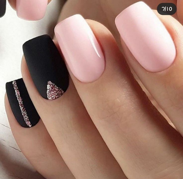 Chic Matte Black and Glossy Light Pink Nail Design with Glitter Accents.