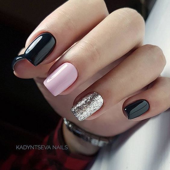 Chic Nail Design: Glossy Black and Soft Pink with Glamorous Silver Glitter Accent.