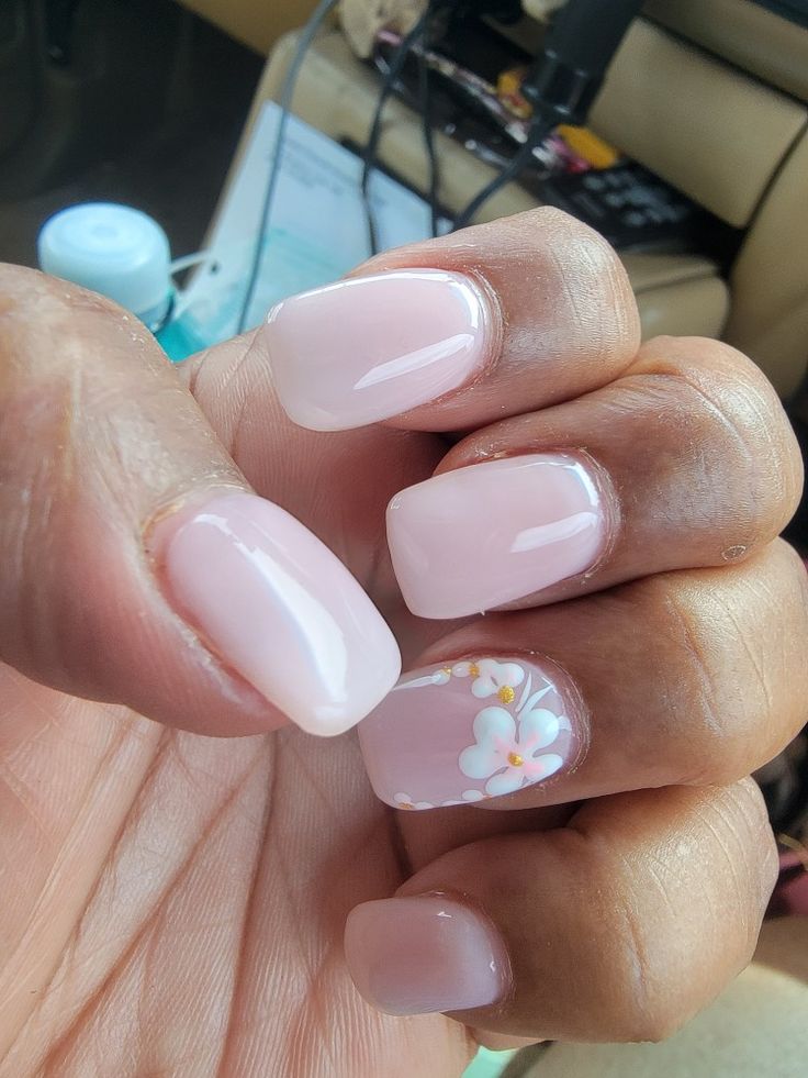 Charming Floral Accent on Soft Pink Square Nails: A Perfect Blend of Simplicity and Creativity.