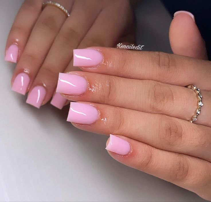 Chic Glossy Pink Nail Design with Feminine Aesthetic and Complementary Rings