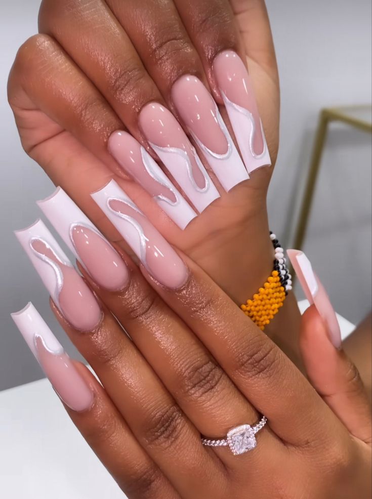 Elegant Nude and White Swirled Long Nails: A Versatile Artistic Look