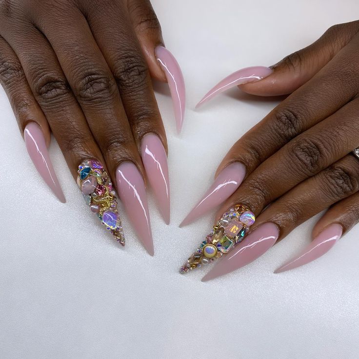 Sophisticated Almond-Shaped Nails: A Blend of Soft Pink Elegance and Glamorous Embellishments.