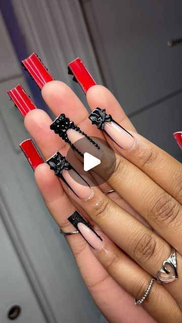 Bold Red and Black Nail Design with Trendy Embellishments for a Standout Statement Style.