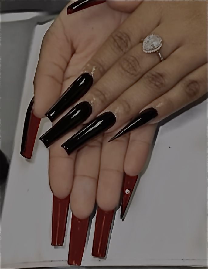 Elegant Long Acrylic Nails: Striking Black and Red Design with Modern Shapes and Gem Accents.