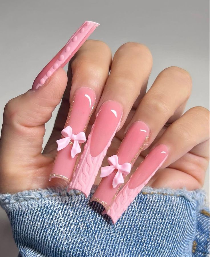 Chic Pink Nail Art: Glossy Finish, Creative Textures, and Delicate Bow Accents for a Playful Feminine Style