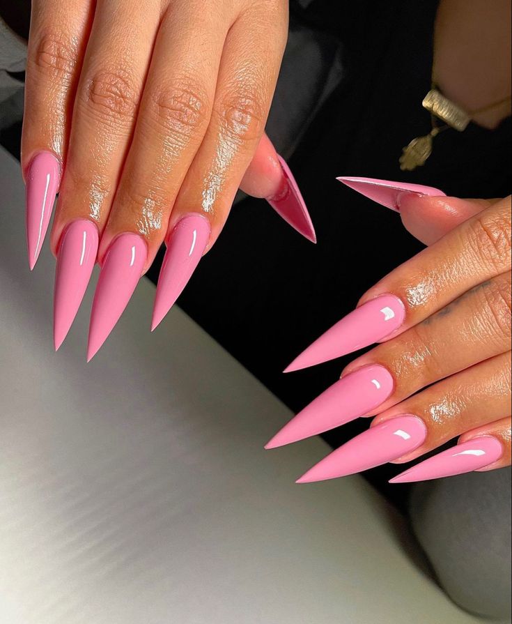 Vibrant Bright Pink Long Stiletto Nails: Elegance Meets Boldness.