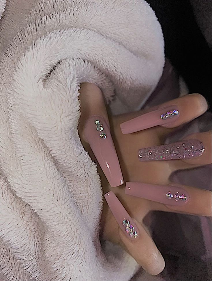 Chic Almond-Shaped Soft Pink Nails Adorned with Glamorous Rhinestones and Textures.