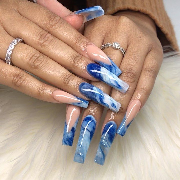 Stunning Vibrant Blue Marble Nail Design with Elegant Tips and Translucent Nude Accents.