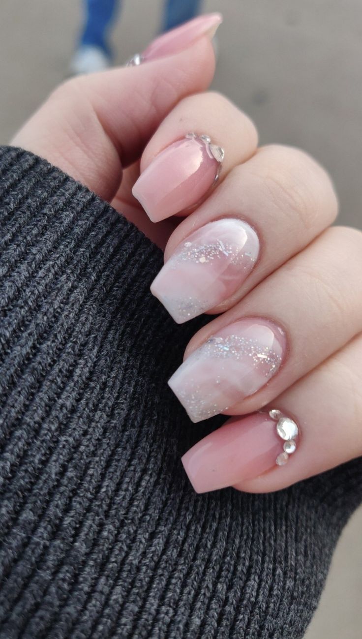 Chic Soft Pink Gradient Nail Design with Glitter and Gemstone Accents