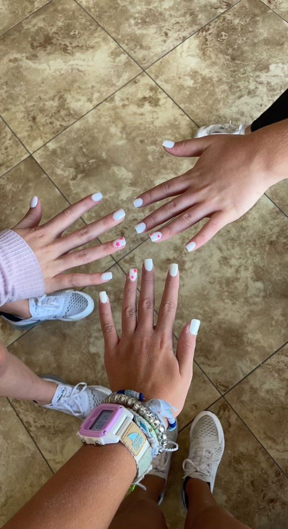 Elegant White and Soft Pink Nail Design: A Trendy Blend of Classic and Whimsical Elements.