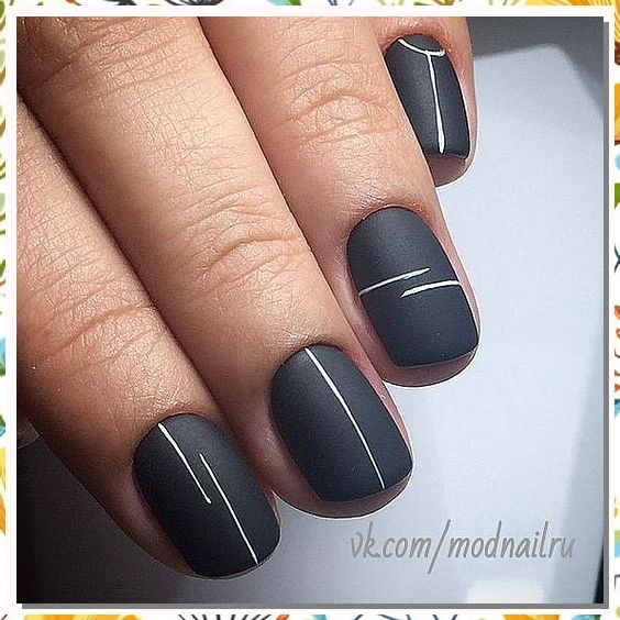 Sleek Matte Black Nails with Minimalist White Accents for a Sophisticated Look.