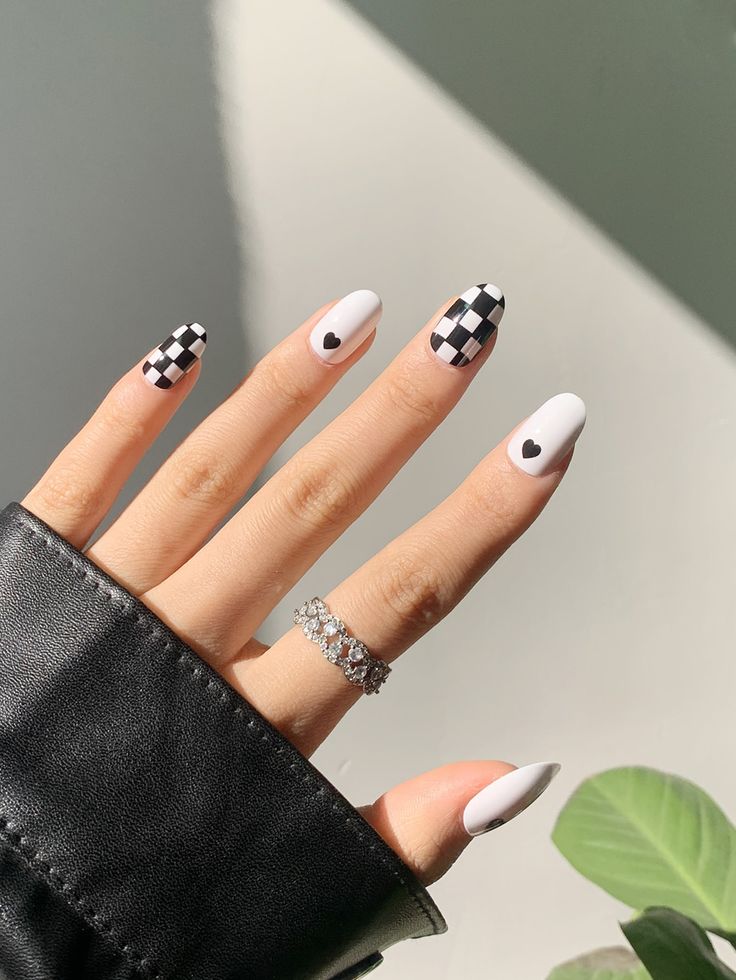 Stylish Matte White and Black Checkered Nail Design with Whimsical Hearts.