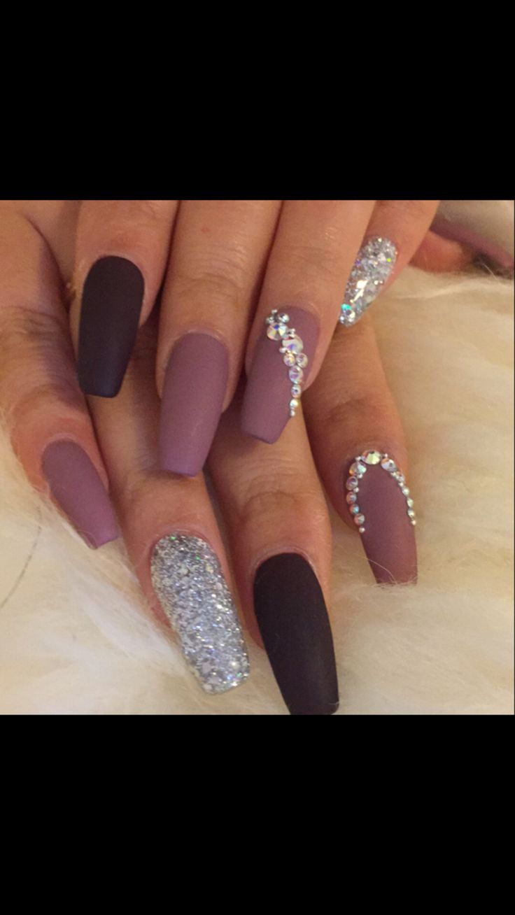 Glamorous Matte and Glitter Nail Design with Purple, Black, and Rhinestones.