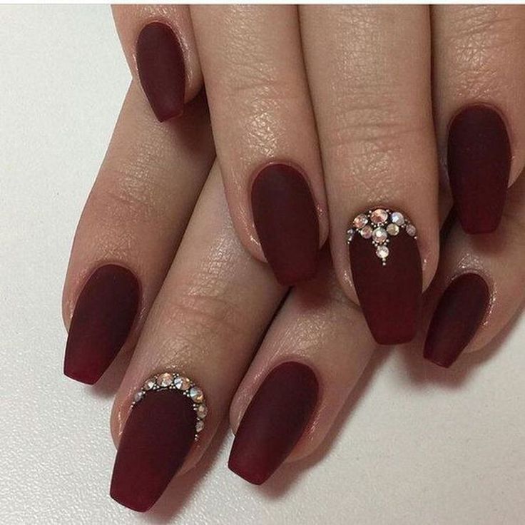 Sophisticated Matte Burgundy Nails with Intricate Crystal Accents for a Touch of Glamour.