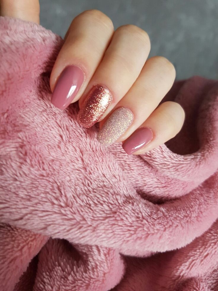 Sophisticated Almond-Shaped Nail Design in Soft Pink with Shimmering Accents and Glitter Highlights.