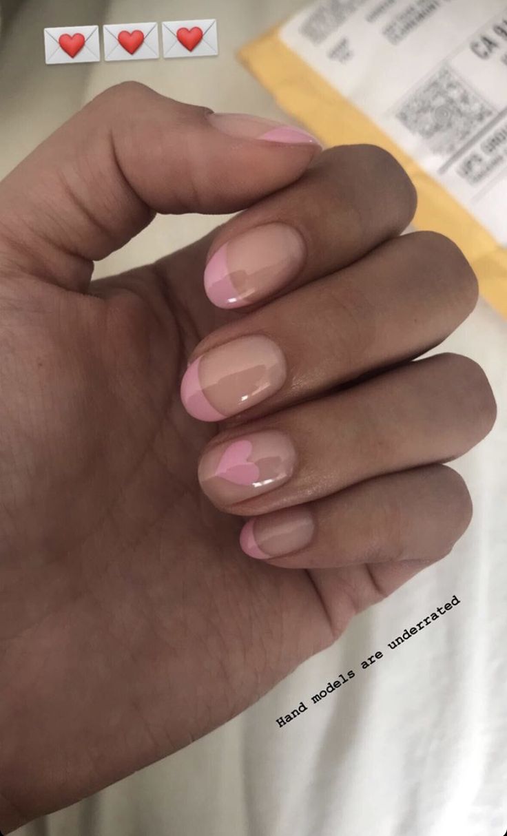 Elegant Nail Design with Natural Base, Pink Tips, and Heart Accents.