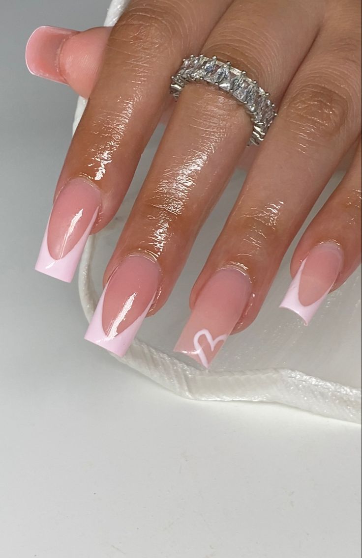 Chic French Tip Nail Design with Soft Pink Gradient and Heart Motif.