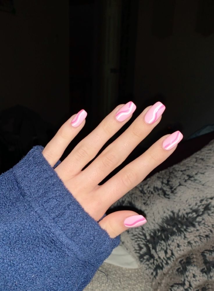 Stylish Pink Nail Design with Creative Wavy White Accents.