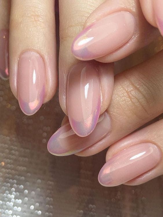 Elegantly Sophisticated Soft Pink Ombre Nail Design with Iridescent Finishes.