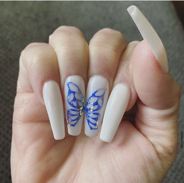 Elegant Butterfly Nail Design: Striking Blue Motif on White Base