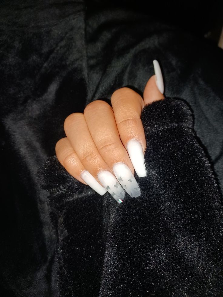 Chic Glossy White Gradient Nail Design with Glamorous Sparkling Accents.