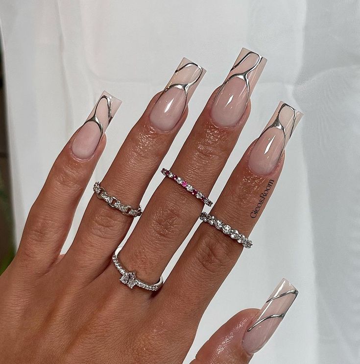 Chic Long Nails with Unique Clear Tips and Swirls Enhance Glamorous Aesthetic.