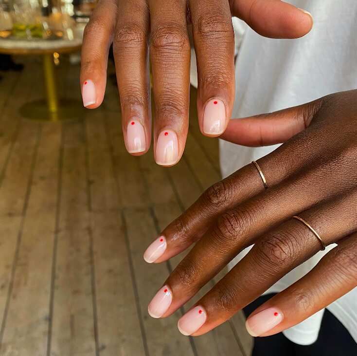 Chic Minimalist Nude Nails with Playful Red Dot Accents