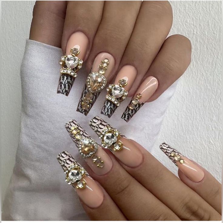 Luxurious Nude Nail Design with Elegant Patterns and Sparkling Rhinestones for Special Occasions.