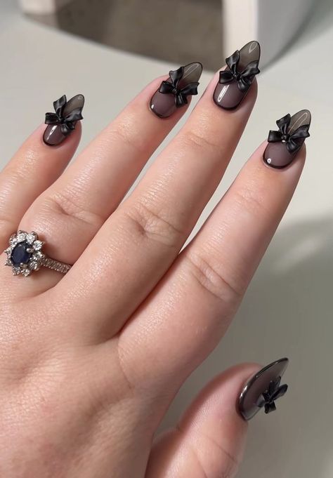 Chic Deep Brown and Transparent Nail Design with Sophisticated Black Bow Accents.