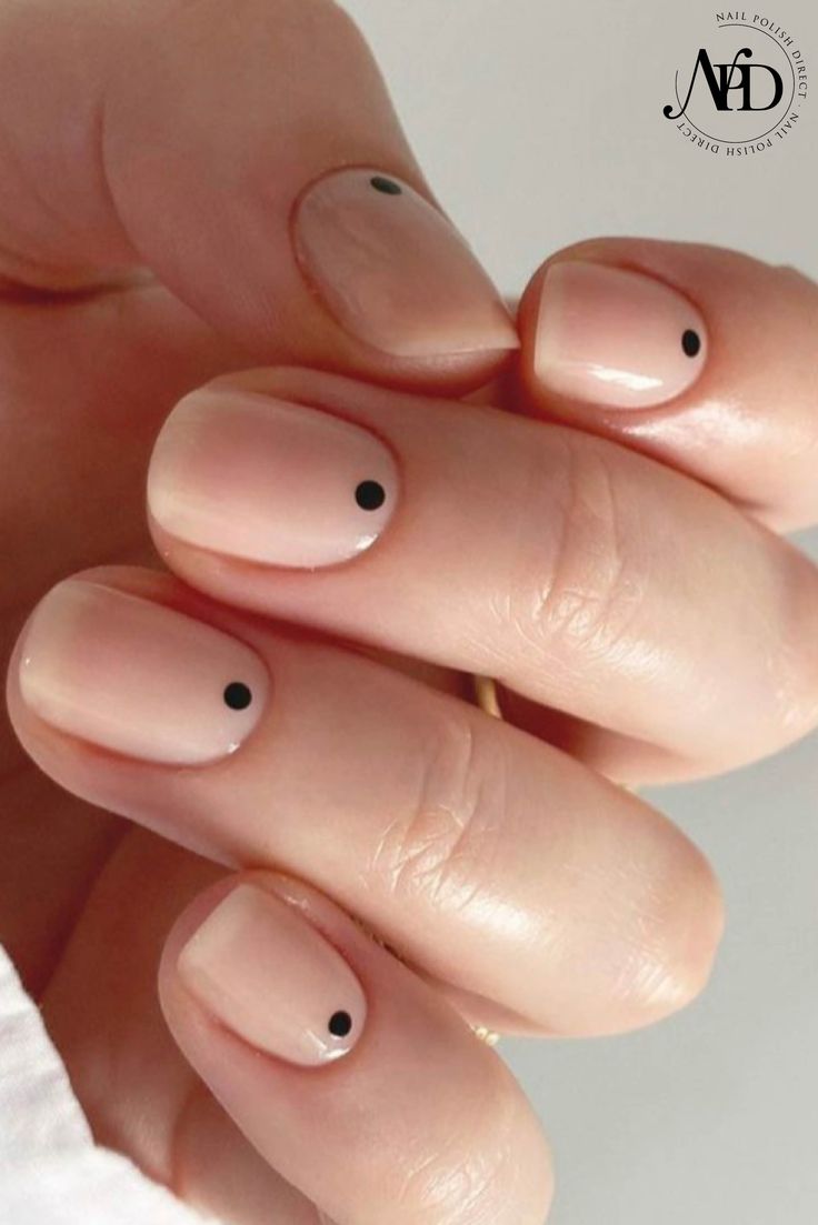 Chic Minimalist Nail Design with Soft Nude Base and Black Dot Accents.