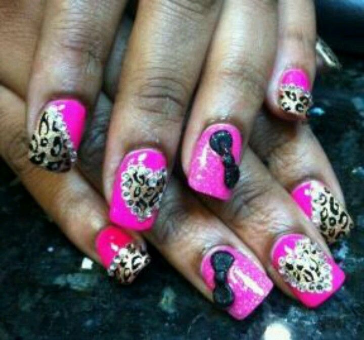 Bold and Glamorous Pink Nail Design with Leopard Print, Glitter, and Bow Accents.