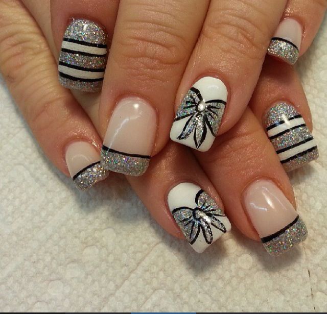 Chic Nail Design: White and Glitter Accents with Bold Stripes and Floral Patterns