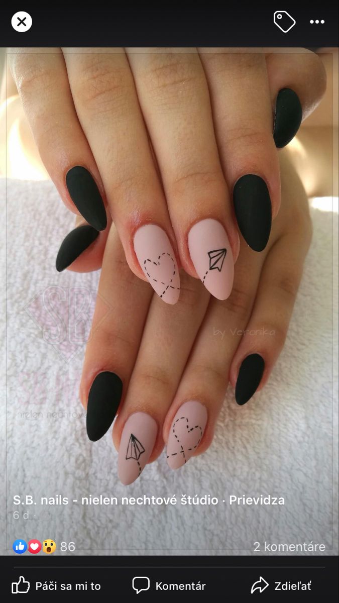 Elegant Matte Black and Soft Pink Nail Design with Delicate Line Art Accents.