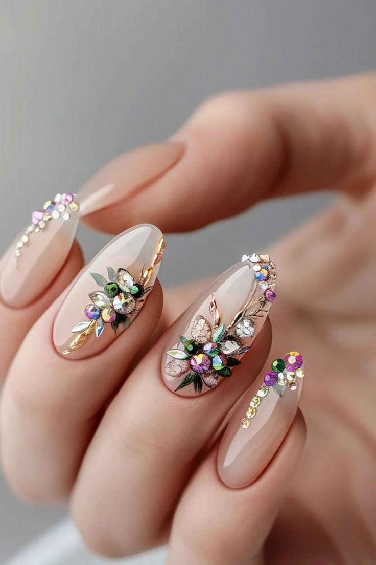 Luxurious Floral Nail Design with Gemstones and Gold Accents.