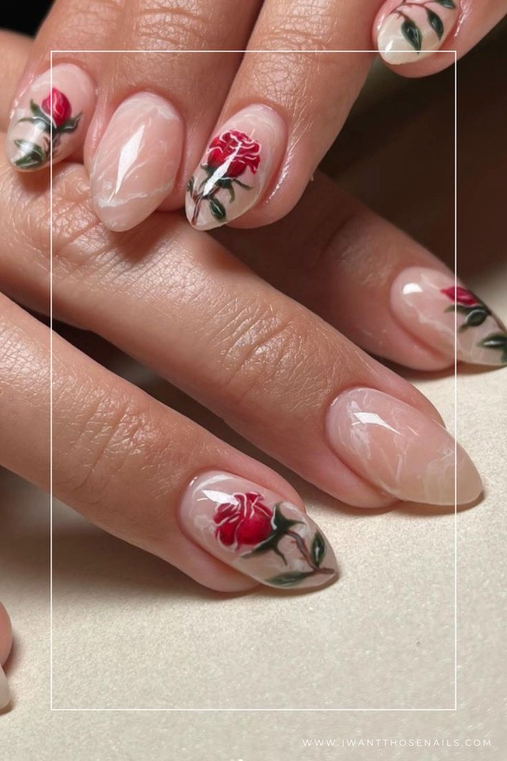 Elegant Floral Nail Design with Red Roses and Green Accents on a Nude Base.