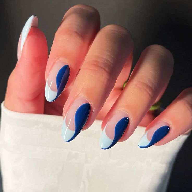 Trendy Wave Pattern Nail Design in Light Blue and Deep Navy with Glossy Finish.