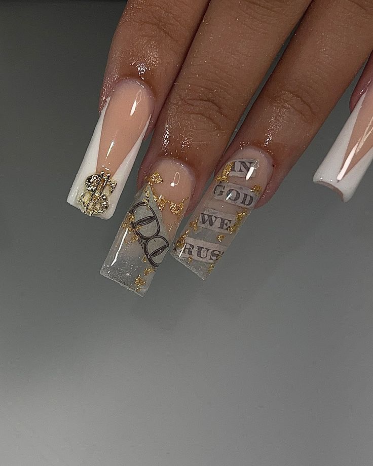 Elegant Nude and White Nail Design with Gold Accents and Bold Graphics