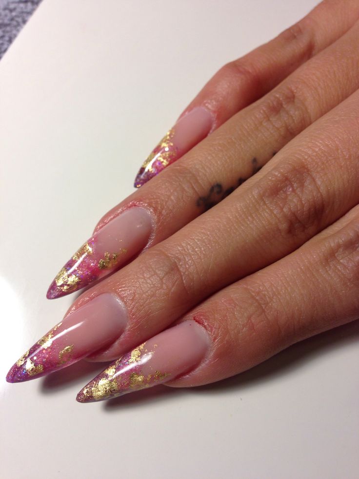 Elegant Stiletto Nails with Gradient Pink and Purple Tips, Enhanced by Luxurious Gold Leaf Accents.