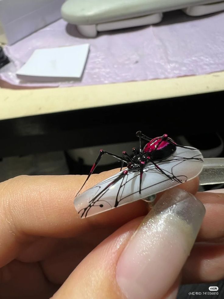 Bold Three-Dimensional Spider Nail Art on Clear Acrylic Base.