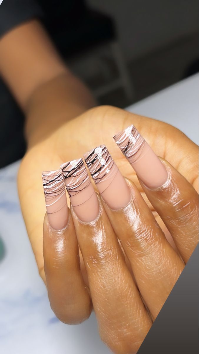 Sleek Nude Nail Design with Wavy Tips and Metallic Accents for a Modern Aesthetic.