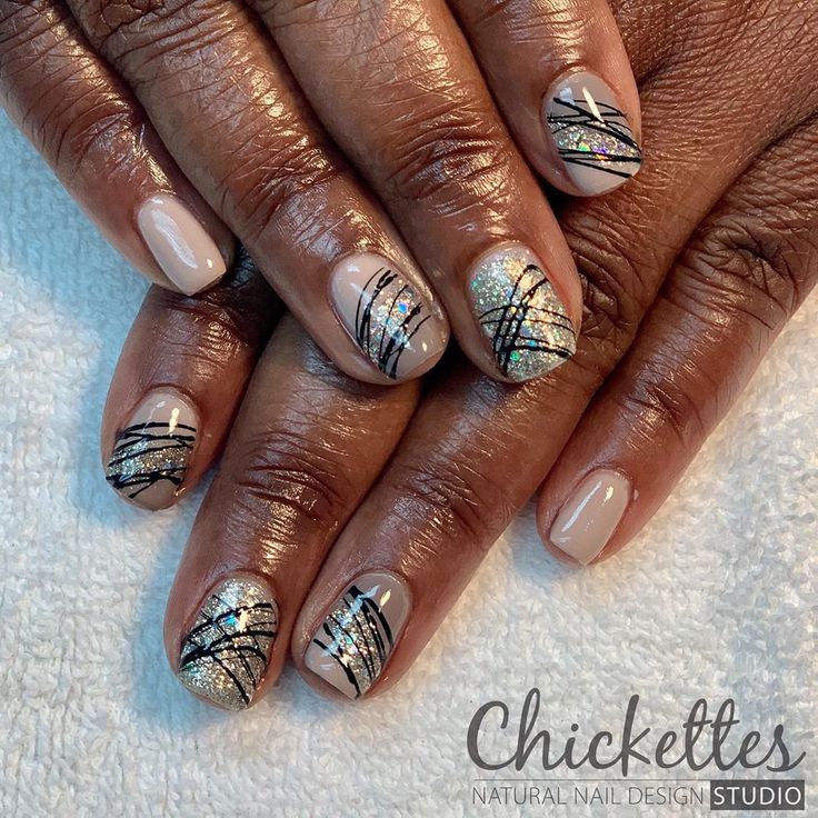 Sophisticated Nail Design: Neutral Base with Silver Glitter and Artistic Black Accents