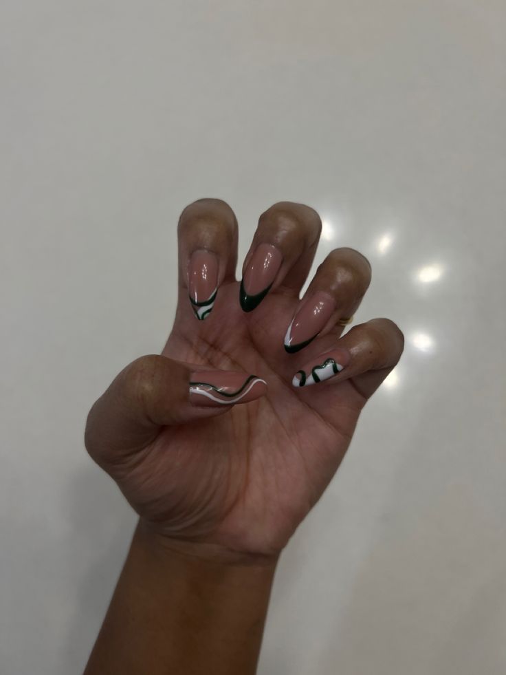 Chic Nude and Green Tip Nail Design with Unique Wavy Patterns.