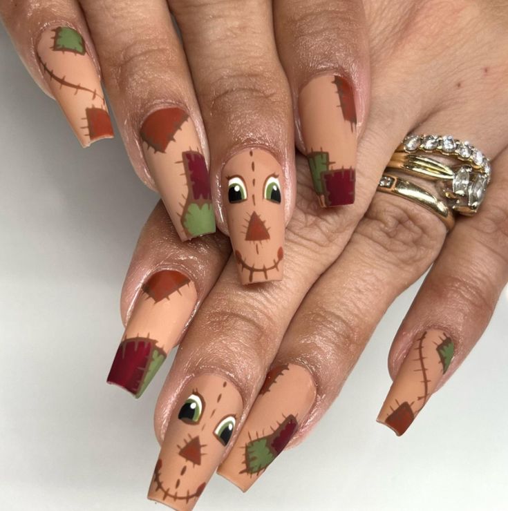 Whimsical Scarecrow-Themed Nail Design with Colorful Patchwork Accents.