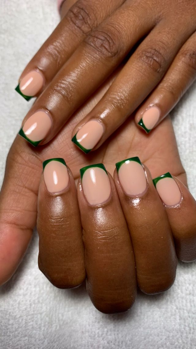 Chic Nude Base with Rich Green Tips: A Stylish Nail Design for Any Occasion.