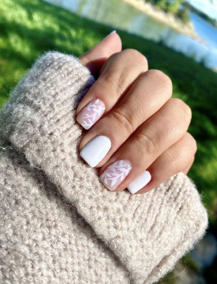 Elegant Matte and Glossy Nail Design with Soft White and Pale Pink Leaf Patterns.