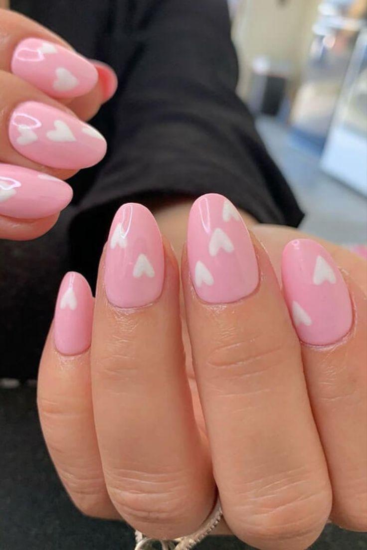 Charming Playful Pink Nail Design with Whimsical Heart Accents.