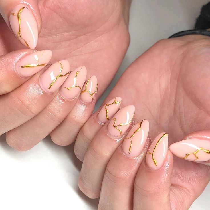 Chic Nude Nails with Gold Foil Accents for a Sophisticated Manicure.