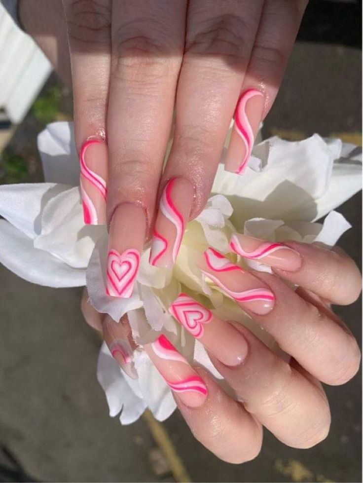 Charming Pink Swirl and Heart Nail Design with Elegant Ombre Finish.