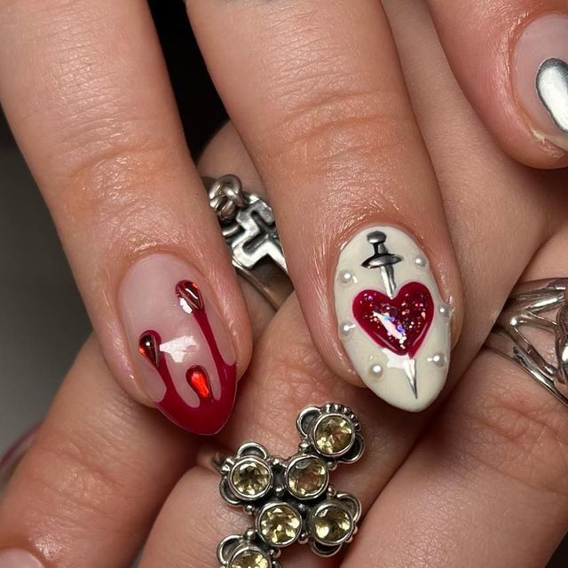 Dramatic Deep Red Nail Design with Blood Drop Effect and Elegant Heart Motif.