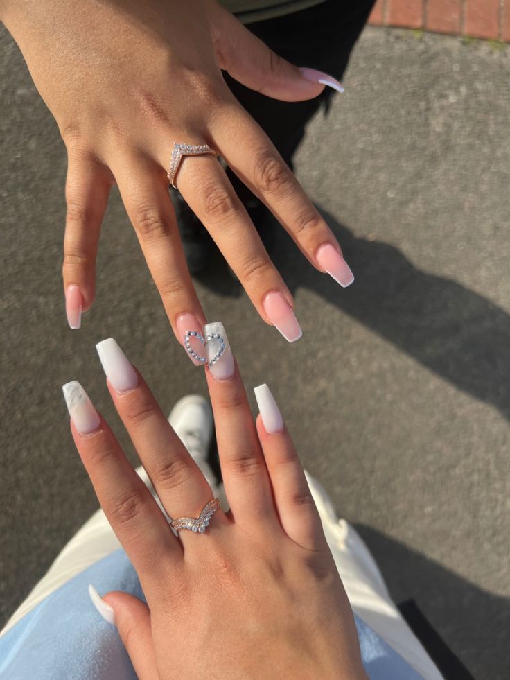 Sophisticated Light Pink and White Nail Designs: French Tips and Heart Detailing with Rhinestones.